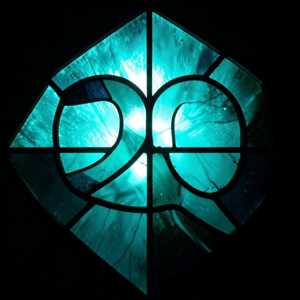 Soft circular emblem with teal and cream tones, gentle and grounded mood.